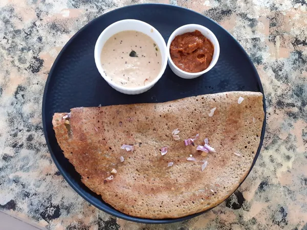 Pesarattu , a dosa made of whole green moong is an important breakfast item served with chutneys. Pic: Sumitra Kalapatapu  