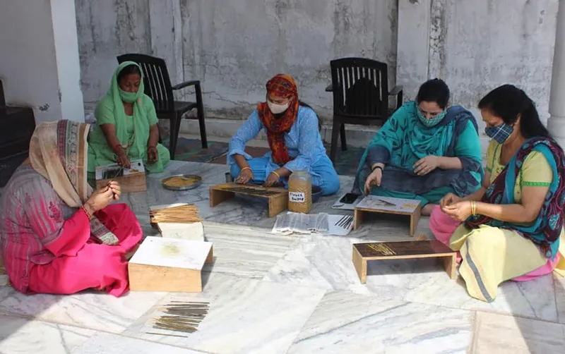 Members of a women SHG making incense sticks from recycled temple flowers. Pic: Disha Volunteer Organization 30stades