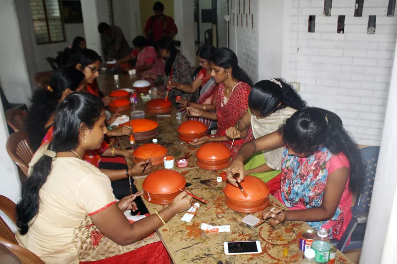 Women painting Theyyam faces on earthen pots. Pic: Folkland Archives 30stades