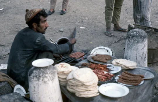 A street vendor selling tujji -- Kashmiri seekh kebab grilled right on the street. Pic: Flickr  30 stades