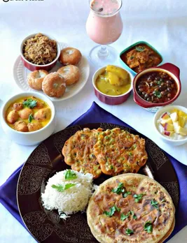 Bhojpuri thali, complete with sattu paratha, green gram fritters (bhabka), kadhi bari, dahi-chuda, balushahi, biryani, yam curry, rice etc