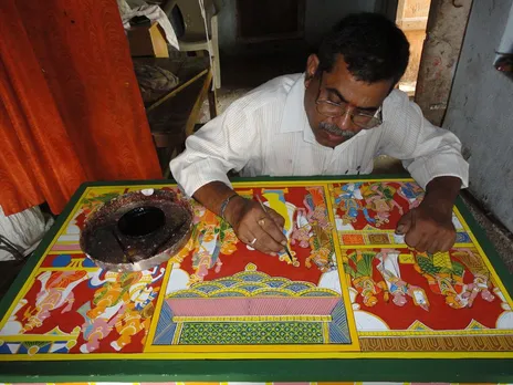 Artist D Vaikuntam Nakash working on a Cheriyal painting. Pic: Facebook/ Vaikuntam Nakash  