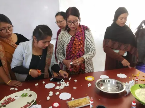 Shrimayum Gita Devi training other women in making cocoon jewellery & handicrafts. Pic:  Leima Liklang Nayin.   30 stades