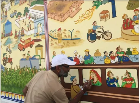 Kalyan Joshi painting on a wall to create awareness around water conservation. 