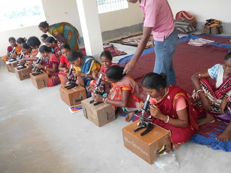 Women undertaking microscopic examination of eggs' health. Pic: Pradan