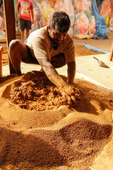 A potter in Kumbharwada, Dharavi, prepares the clay.