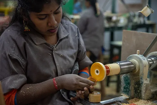 A woman artisan using a lathe to make Channapatna toys. Pic: Flickr 30stades