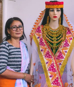 Shrimayum Gita Devi stands with a mannequin sporting cocoon headgear, earrings and necklace. Pic: Leima Liklang Nayin