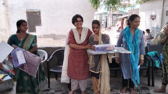 Smriti Kedia, the CEO of Sadhna, giving a kit to a young artisan. Pic: Sadhna 30stades