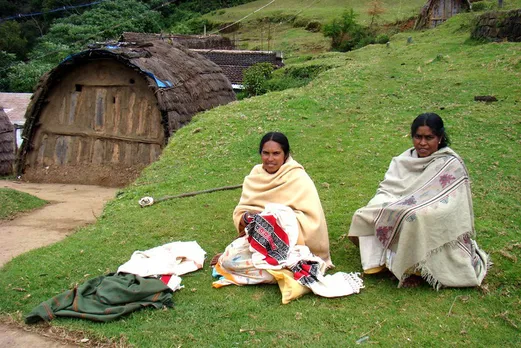 The Toda tribe inhabits the Nilgiris, which form part of the Ghats in northwestern Tamil Nadu. A woman is practising Toda embroidery and their traditional house is in the background. Pic: Flickr 30stades