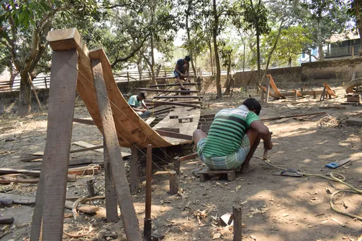 Workers preparing the backbone of boat at a unit in Balagarh
