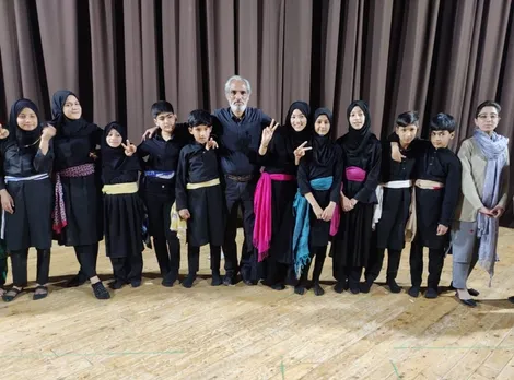 Hakeem Javed with children on stage after a performance. Pic: Shehjar Children's Theatre Group 30stades