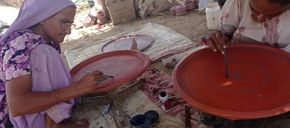 Women painting on the pottery which has been quoted with geru (reddish colour). Pic: Abdulbhai 30 stades khavda pottery