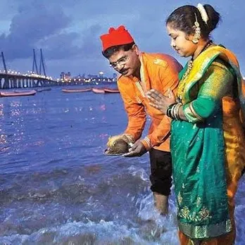 A Koli couple offering coconut to the sea on Narial Poornima. Pic: Flickr