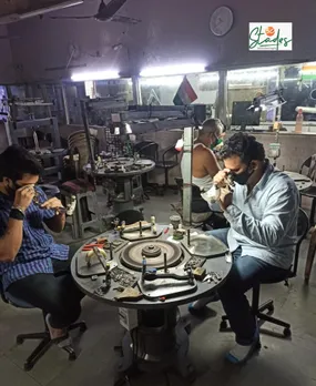 Workers checking diamonds after polishing at Kirti Shah's unit
