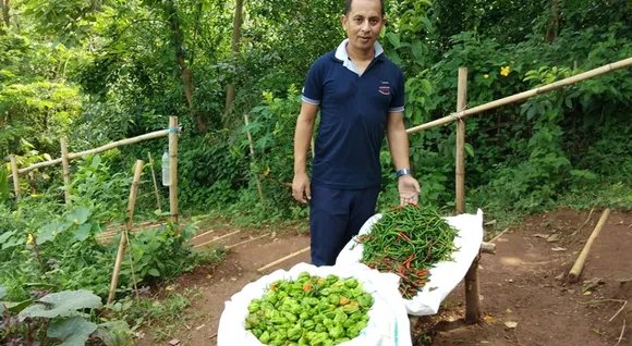 With his produce from the forest. Pic: Facebook/@SamirBordoloi