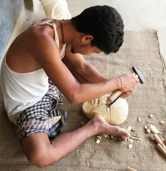 A craftsman crafting a Kushmandi wooden mask using chisel and hammer. Pic: Courtesy Parikshit Sarkar & Paramesh Sarkar 30stades