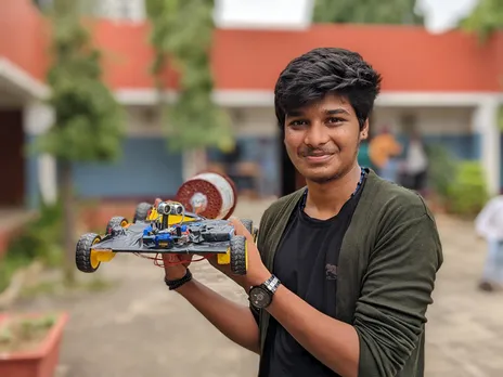 Prem Sagar, 17, holding the robotic vacuum cleaner he has made. Pic: Project DEFY 30STADES