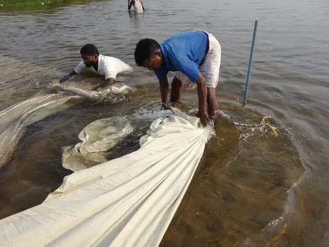 Fabric is tied with a rope while washing in the river. It is the fifth step in the seven-step process. Pic: Pitchuka Srinivasa 30 stades