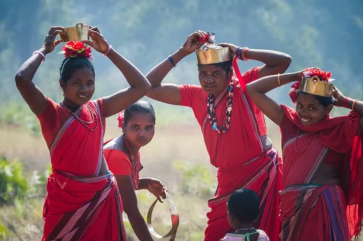 Women wear colourful, mostly red and orange sarees and wear metallic headgear. Pic: Flickr 30stades