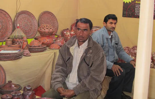 Abdulbhai at an exhibition with his Khavda pottery. Pic: Khamir